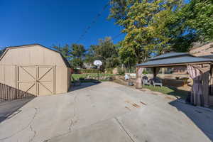 Exterior space featuring a gazebo and a storage unit