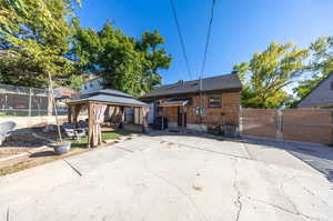 Back of house featuring a gazebo and a patio area