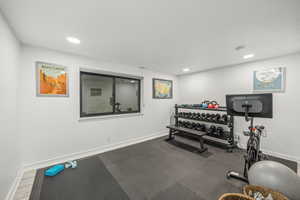 Workout room featuring hardwood / wood-style floors