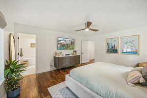 Bedroom featuring dark hardwood / wood-style flooring, ceiling fan, and ensuite bathroom