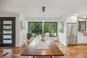 Unfurnished dining area with light hardwood / wood-style floors, crown molding, and sink