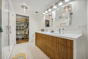 Bathroom featuring hardwood / wood-style floors, a shower with shower door, vanity, and toilet