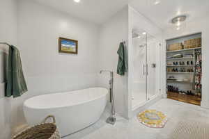 Bathroom with tile patterned flooring and plus walk in shower