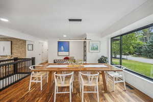 Dining room with hardwood / wood-style flooring and ornamental molding