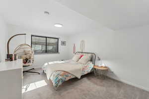 Bedroom featuring light colored carpet