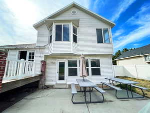 Back of property with a patio