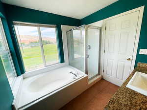 Bathroom with vanity, a mountain view, tile patterned floors, and separate shower and tub