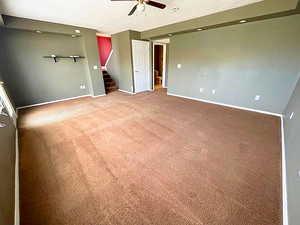 Carpeted spare room with ceiling fan