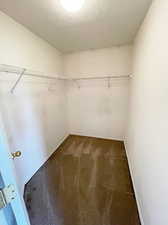 Walk in closet featuring dark carpet