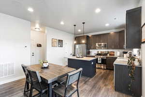 Dining area featuring sink and dark wood-type flooring