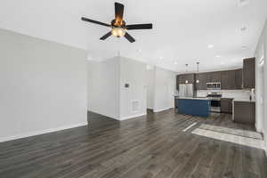 Family room/great room with dark wood-type flooring, recessed lighting, and a ceiling fan