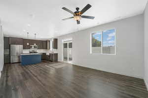 Unfurnished living room featuring dark wood finished floors, ceiling fan, and recessed lighting
