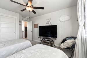 Bedroom featuring ceiling fan and light colored carpet