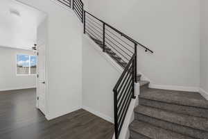 Entryway Stairway with wood finished floors and a ceiling fan
