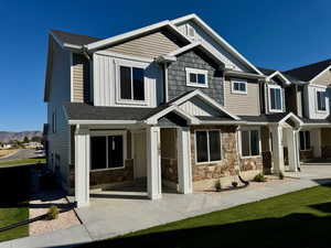 Back of property with a yard and a mountain view