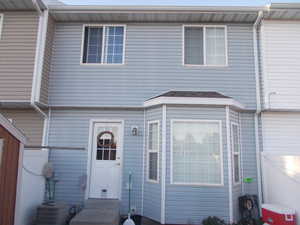 View of front of house with central air condition unit