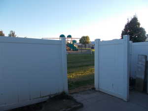 View of gate featuring a lawn