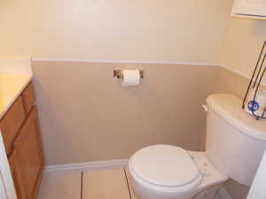 Bathroom featuring vanity, toilet, and tile patterned floors