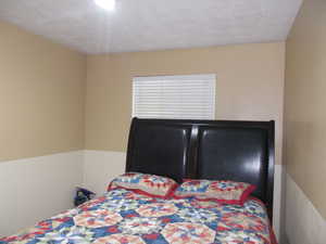 Bedroom featuring a textured ceiling