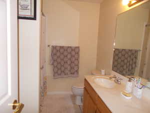 Bathroom with tile patterned floors, vanity, and toilet