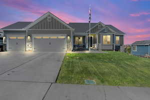 Craftsman-style house with a yard and a garage