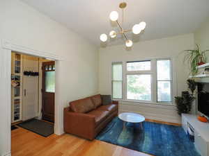 Living room with a notable chandelier and light wood-type flooring