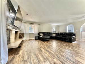 Living room with hardwood / wood-style flooring and a textured ceiling