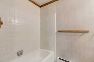 Bathroom featuring  shower combination and crown molding