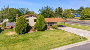 View of front of home featuring a front yard and a carport