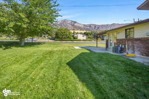 View of yard featuring a mountain view, and a patio