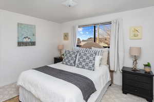 Bedroom featuring light carpet