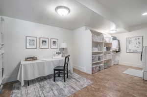 Office area featuring a textured ceiling