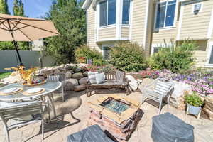 View of patio / terrace with an outdoor gas fire pit and pond- less waterfall