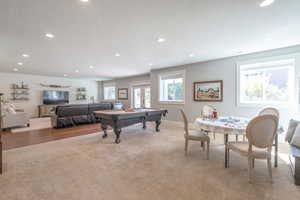 Rec room featuring pool table, a textured ceiling, and light carpet