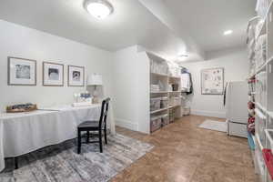 Kitchen featuring a textured ceiling, light tile patterned floors, and washer / dryer