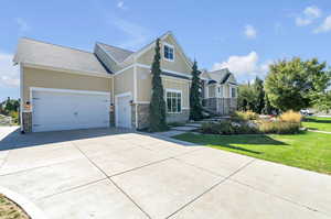 Craftsman-style home with a front yard and a garage