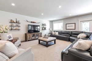 Living room with a textured ceiling and light colored carpet