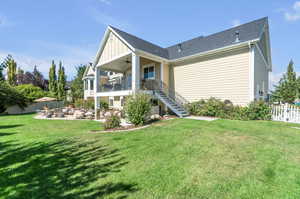 Back of property featuring a lawn, ceiling fan, and a patio area