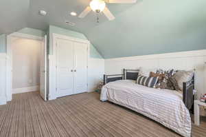 Bedroom with a closet, lofted ceiling, ceiling fan