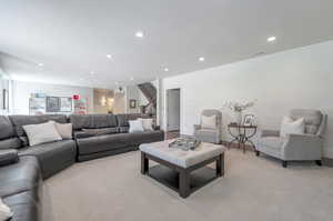 Carpeted living room with a textured ceiling