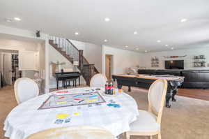 Dining space featuring light carpet and pool table