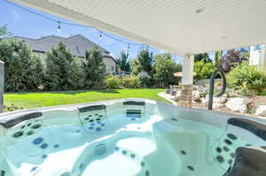 View of hot tub and a yard