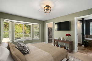 Bedroom with a textured ceiling, a closet, and a walk in closet