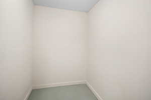 Unfurnished room with a textured ceiling and concrete floors