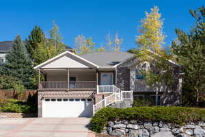 View of front of house featuring covered porch and a garage