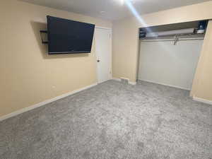 Unfurnished bedroom featuring a closet and carpet