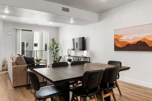 Dining room featuring light wood-type flooring and a textured ceiling