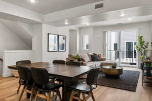 Dining area with a textured ceiling and light hardwood / wood-style floors