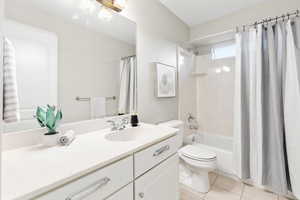 Full bathroom featuring tile patterned flooring, vanity, shower / tub combo, and toilet