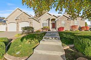 View of front facade with a garage and a front lawn